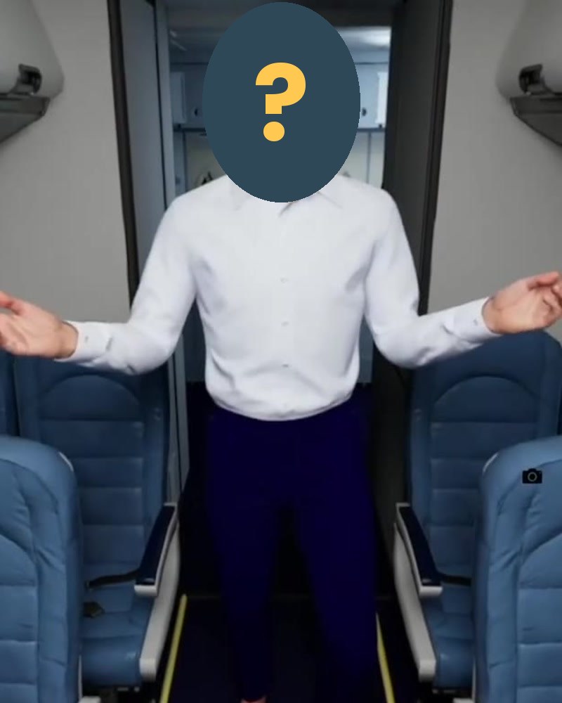 The CG crew member standing in the cabin with his arms open, his face covered by a question mark